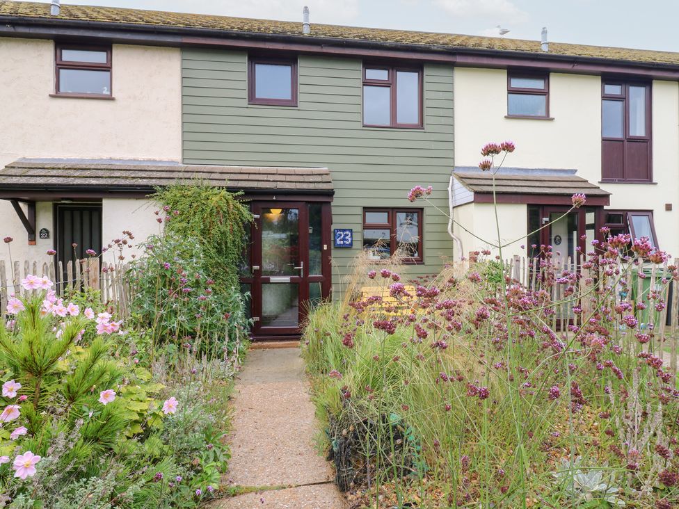A house with a front door and garden at Coastguard Cottage in Rye