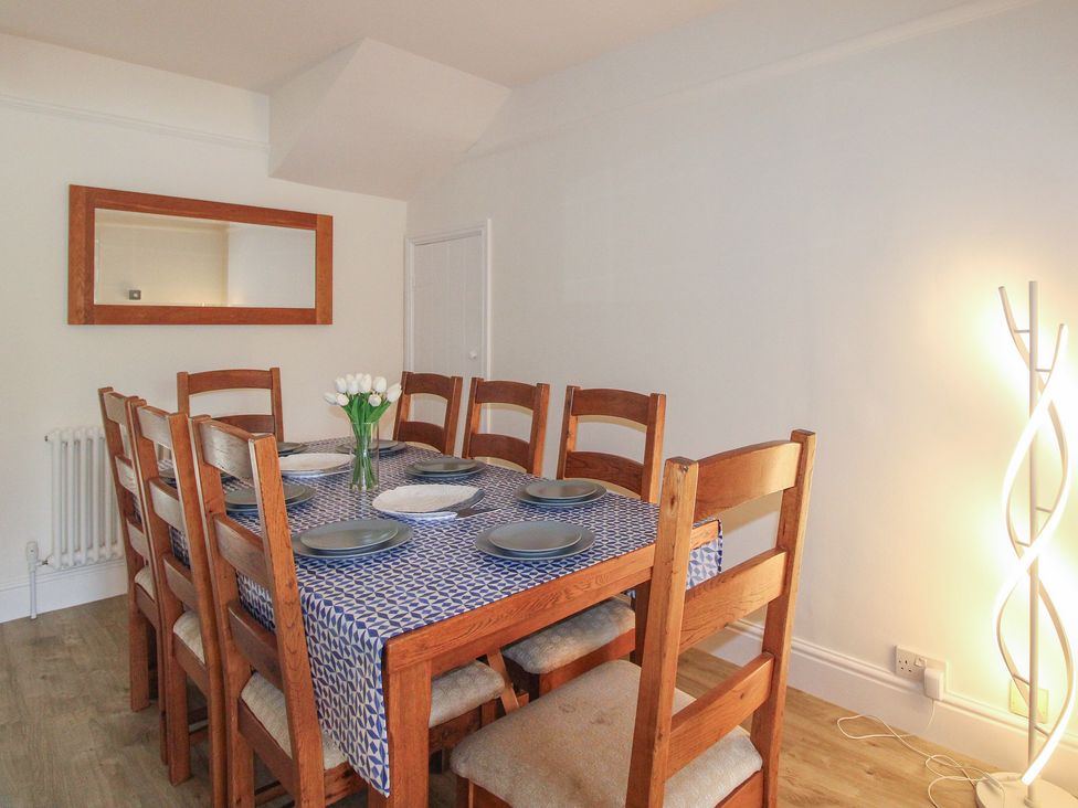 A dining room with a table set for dinner at Home in Salcombe