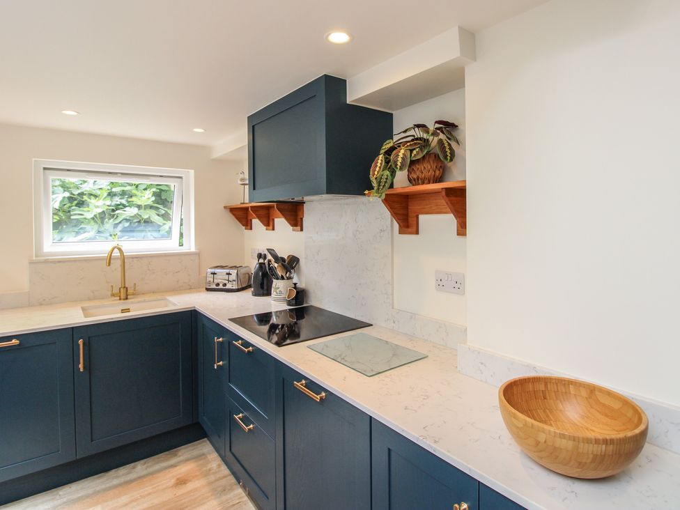 A kitchen with cabinets and countertop at Home in Salcombe