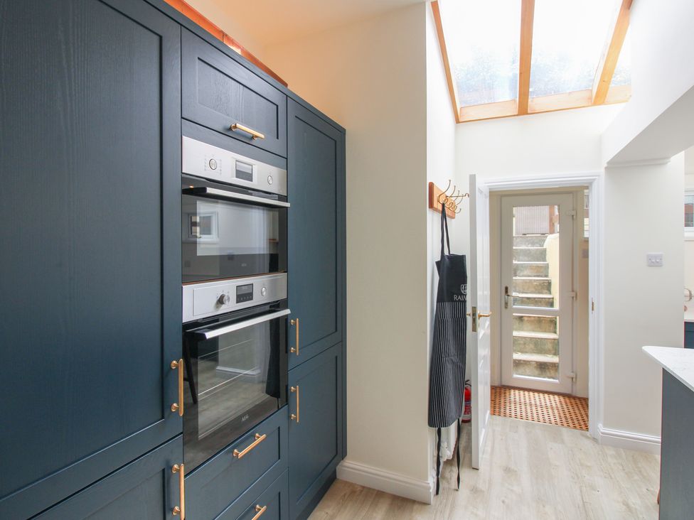 A kitchen with kitchen cabinets and an oven at Home in Salcombe