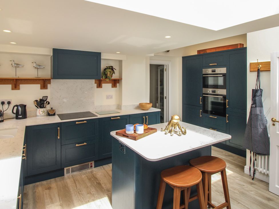 A kitchen with a stove, oven, and sink at Home in Salcombe