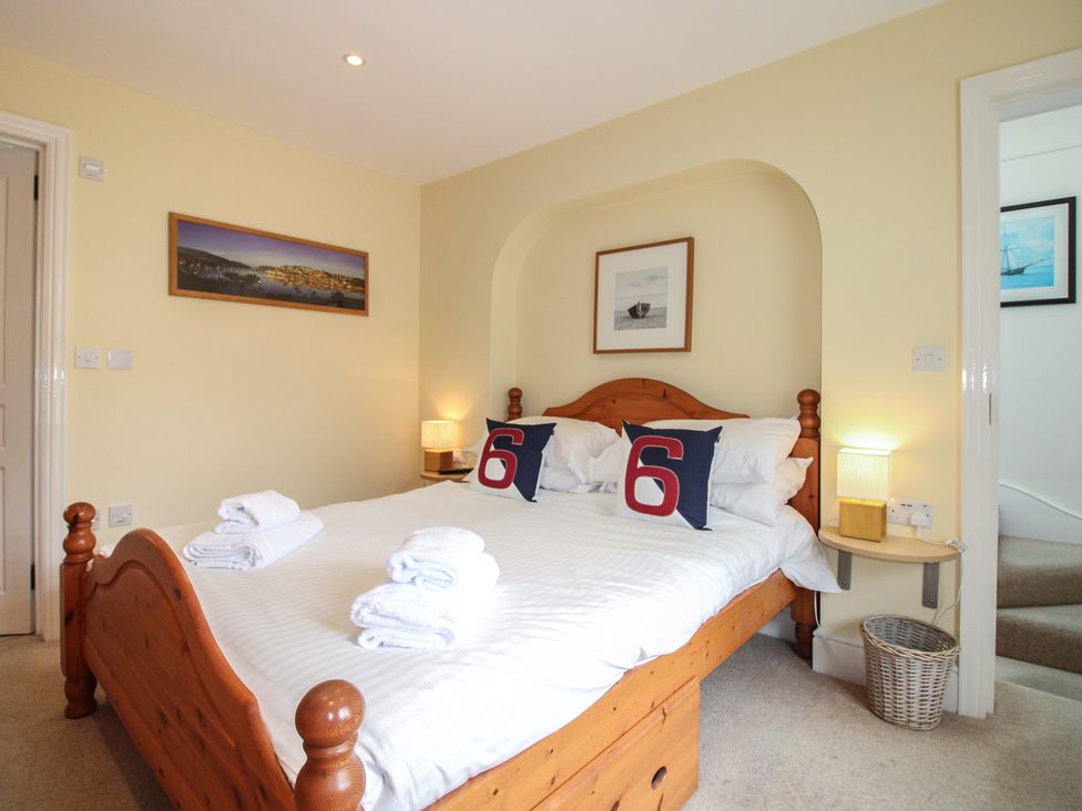 A bedroom with a bed and lamp at Home in Salcombe