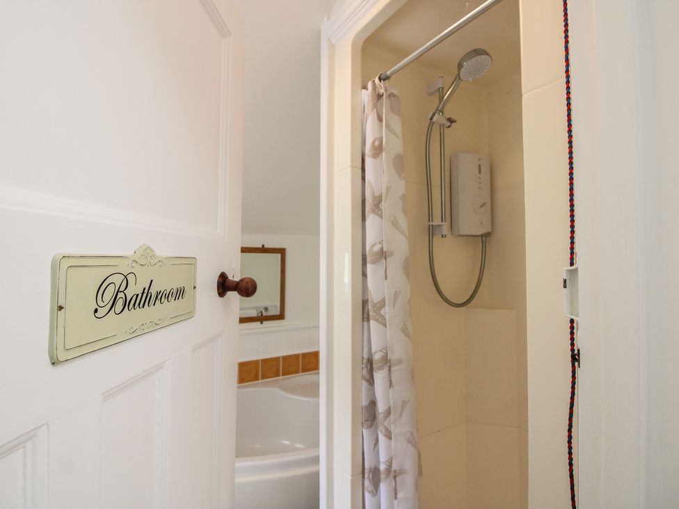 A bathroom with a shower and a bathtub at Home in Salcombe