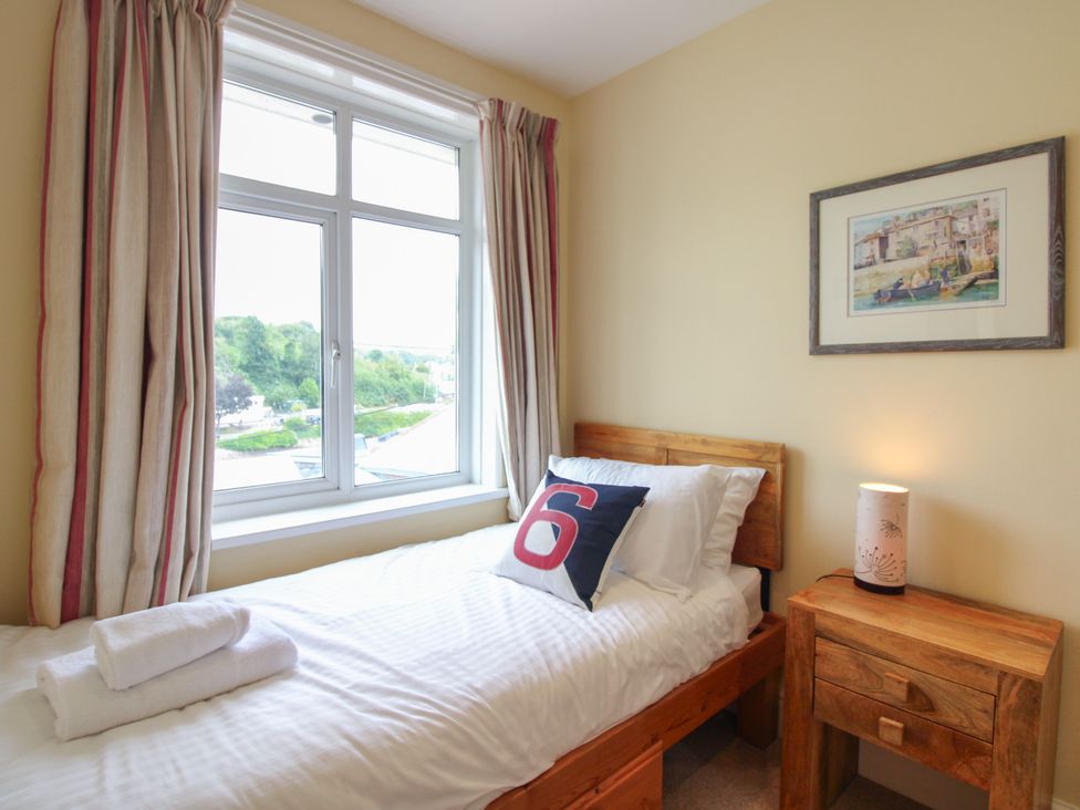 A bedroom with a single bed and a bedside table at Home in Salcombe