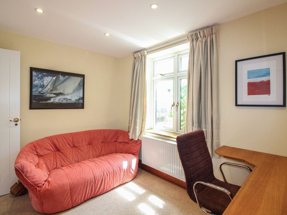 A home office with a sofa and desk at Home in Salcombe