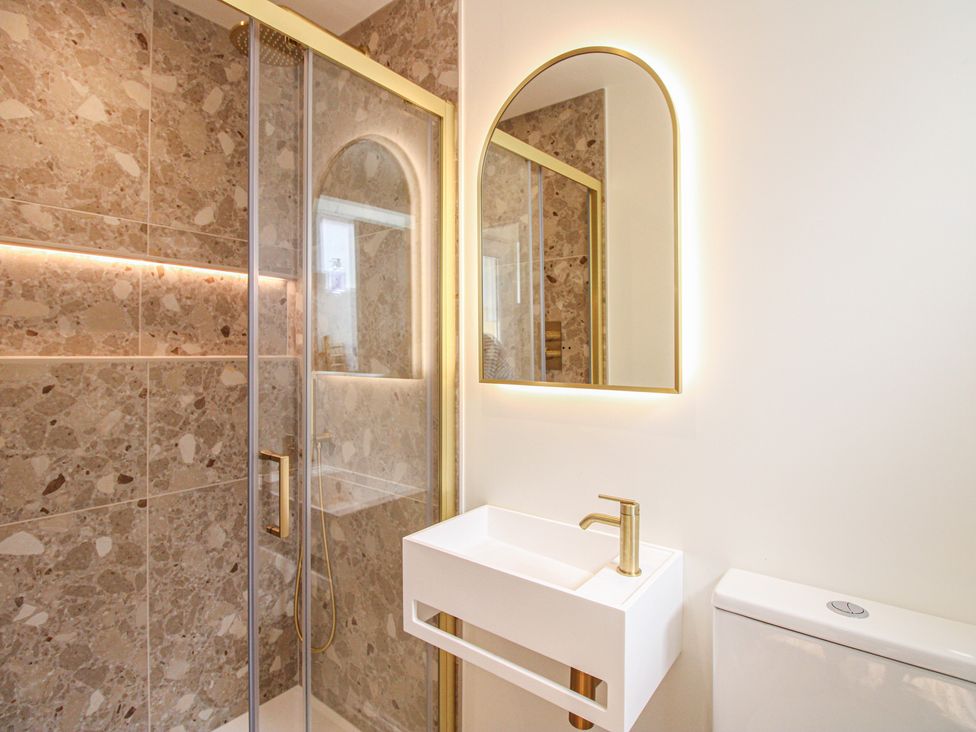 A bathroom with a shower and a wash basin at Home in Salcombe