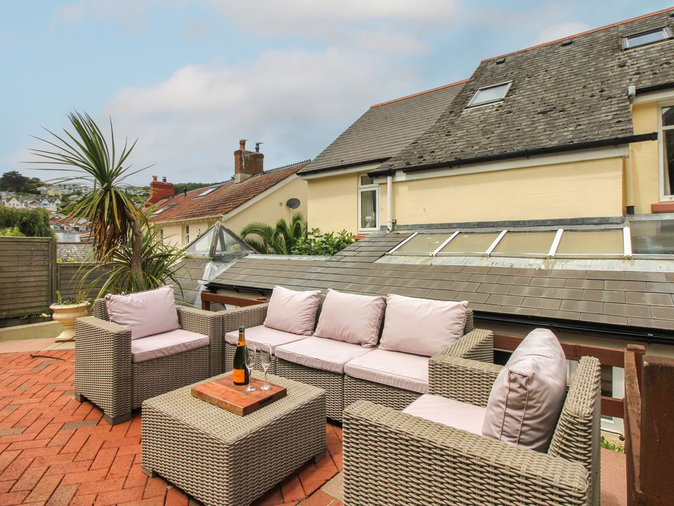 An outdoor patio with seating and a coffee table at Home in Salcombe