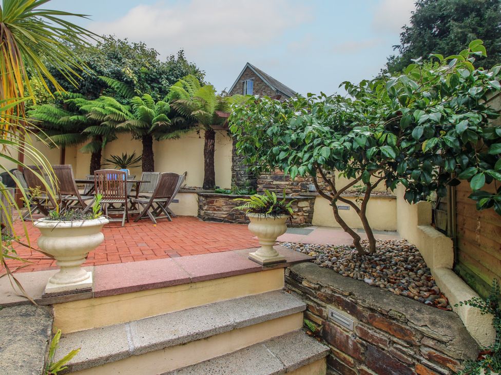 A garden with a patio table and chairs at Home in Salcombe