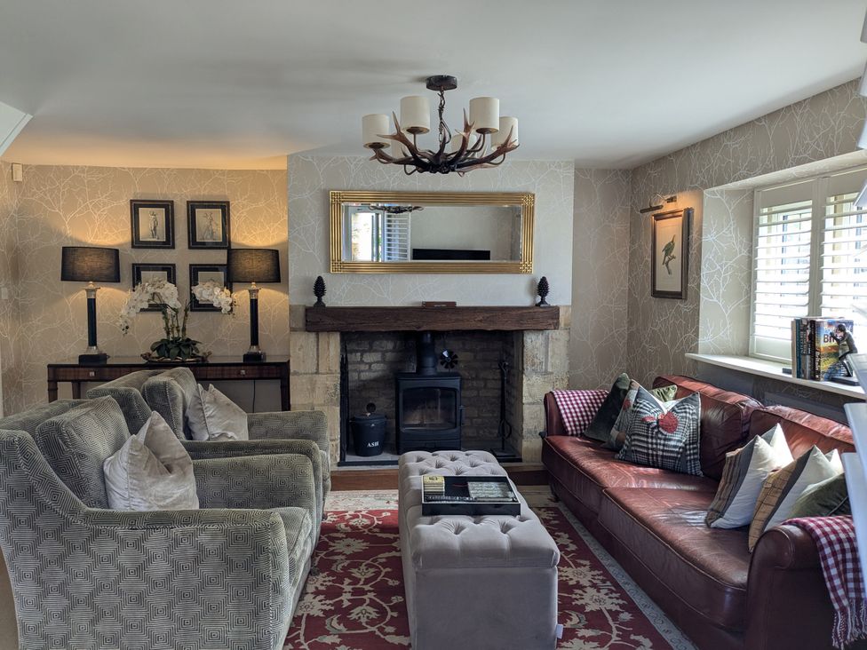 A living room with a coffee table and fireplace at Mill Stream Cottage Lower Slaughter near Bourton-On-The-Water