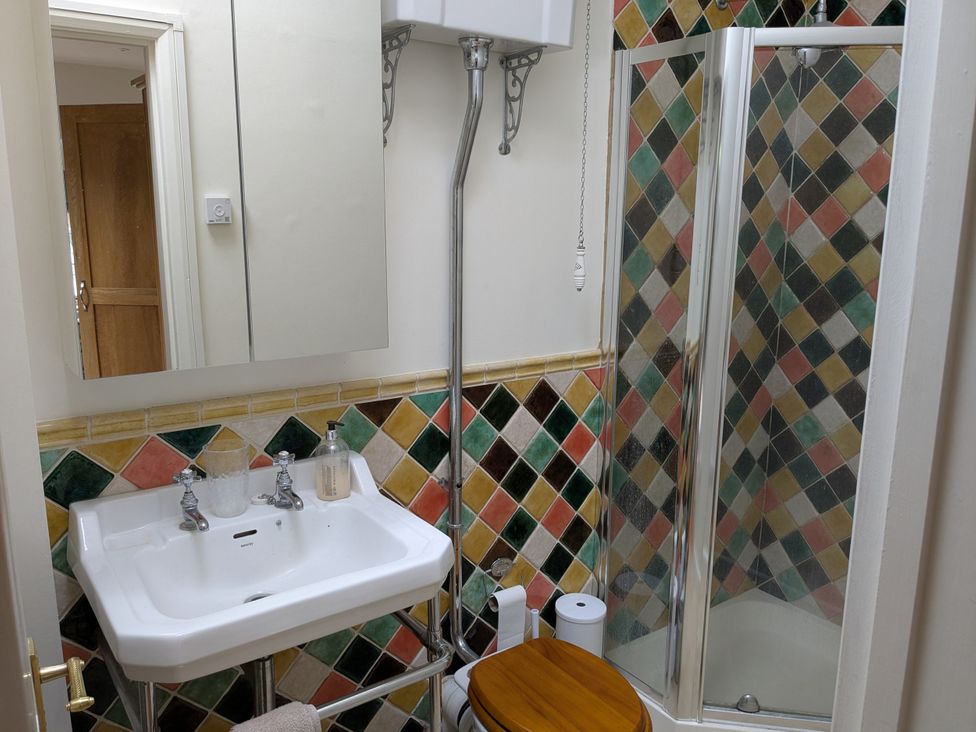 A bathroom with a sink and shower at Mill Stream Cottage Lower Slaughter near Bourton-On-The-Water