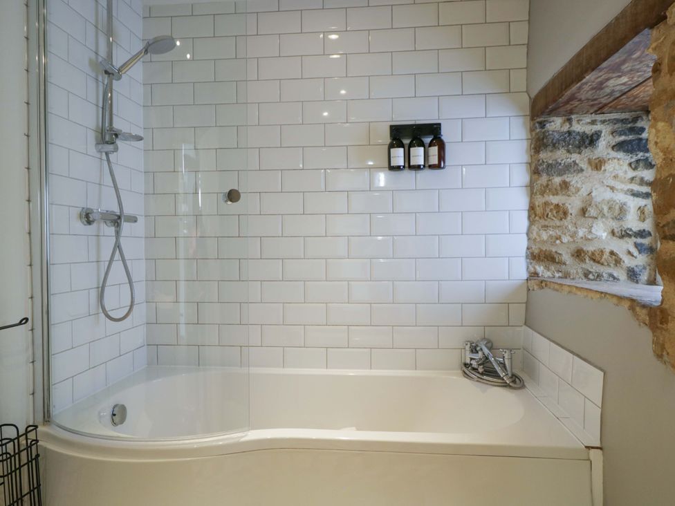 A bathroom with a bathtub and shower at The Tap Room in Kingham