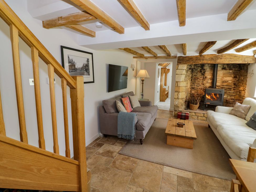 A living room with a sofa and fireplace at Wyncliffe in Chipping Campden