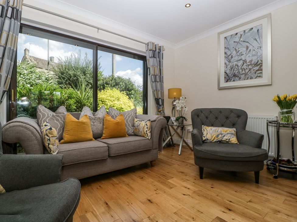 A living room with a sofa and armchair at Bell Garden in Stow-On-The-Wold
