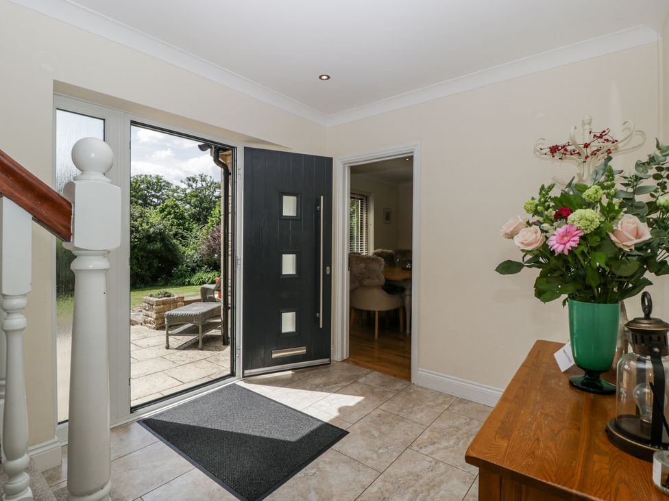 An entrance hall with a door and staircase at Bell Garden in Stow-On-The-Wold