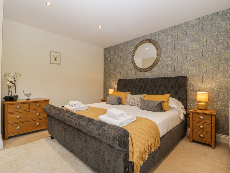 A bedroom with a bed and wooden furniture at Bell Garden in Stow-On-The-Wold
