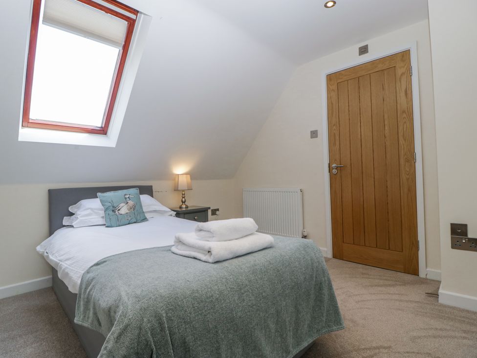 A bedroom with a bed and a window at Bell Garden in Stow-On-The-Wold