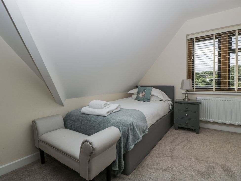 A bedroom with a single bed and a chair at Bell Garden Stow-On-The-Wold