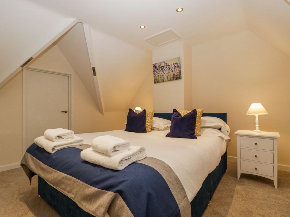 A bedroom with a bed and nightstand at Bell Garden in Stow-On-The-Wold