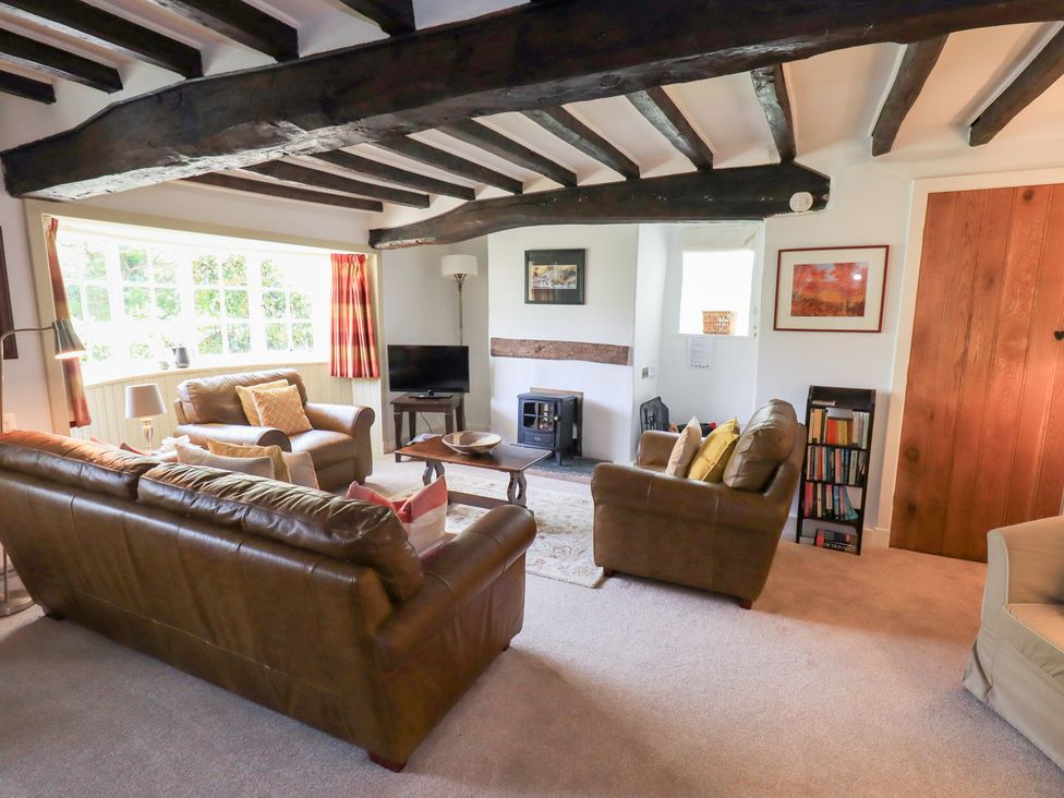 A living room with sofas and a coffee table at Burnside Cottage in Braithwaite