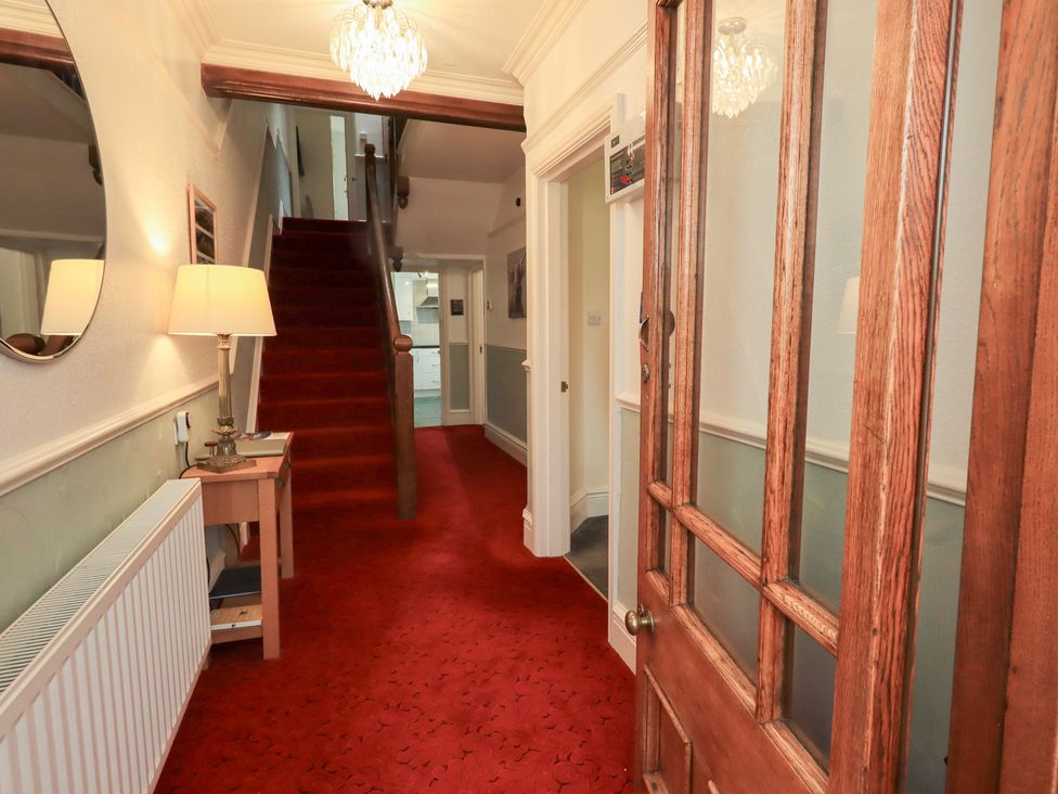 A hallway with a staircase leading to the upper floor at Hazelmere, Keswick