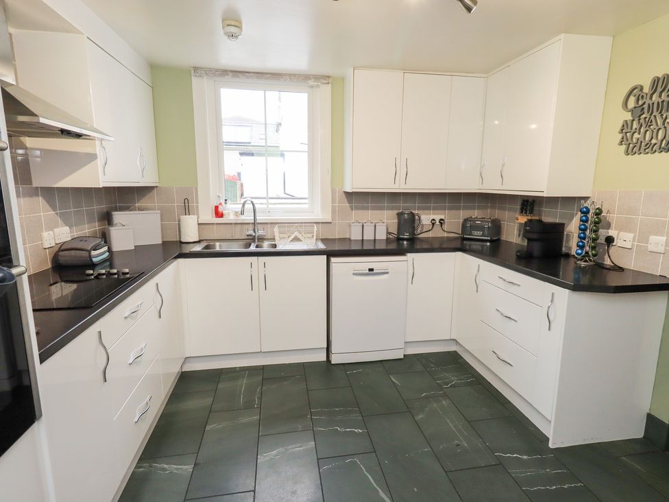 A kitchen with appliances and sink at Hazelmere in Keswick