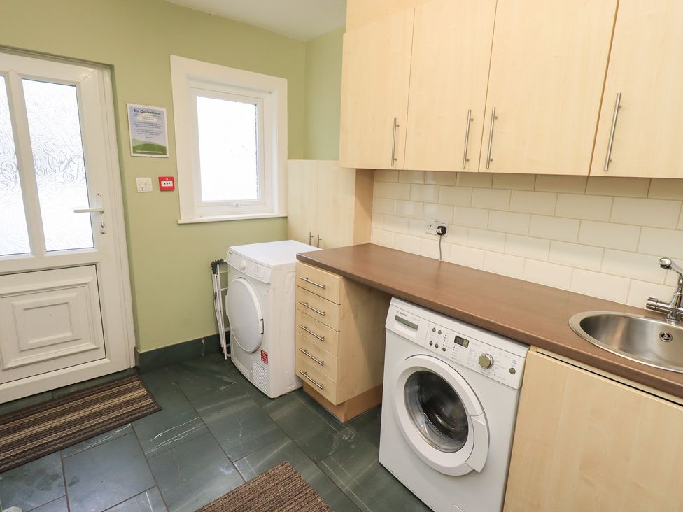 A laundry room with a washing machine and sink at Hazelmere in Keswick