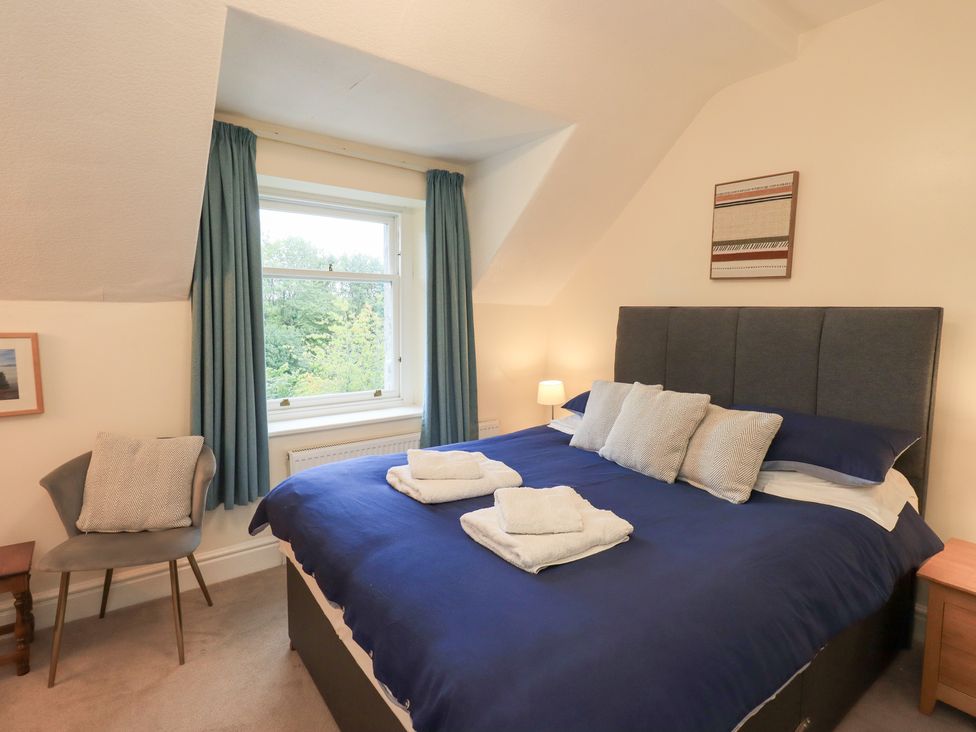 A bedroom with a bed and window at Hazelmere in Keswick