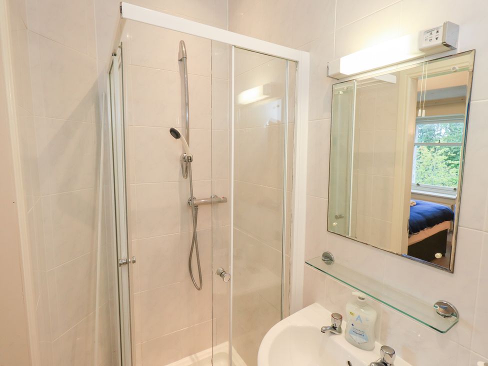 A bathroom with a shower and washbasin at Hazelmere, Keswick