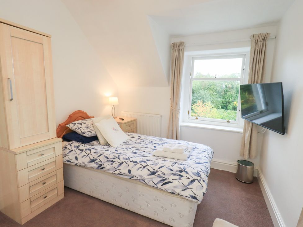 A bedroom with a bed and wardrobe at Hazelmere in Keswick