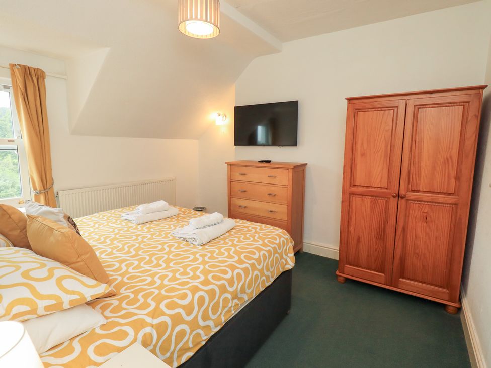 A bedroom with a bed and wardrobe at Hazelmere in Keswick