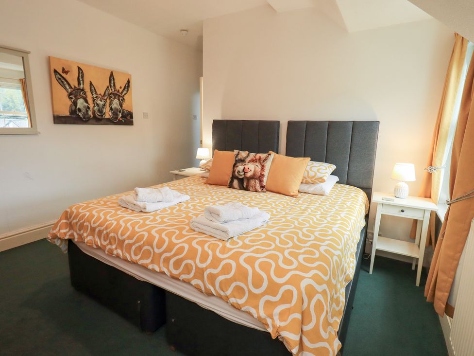 A bedroom with a bed and nightstand at Hazelmere in Keswick