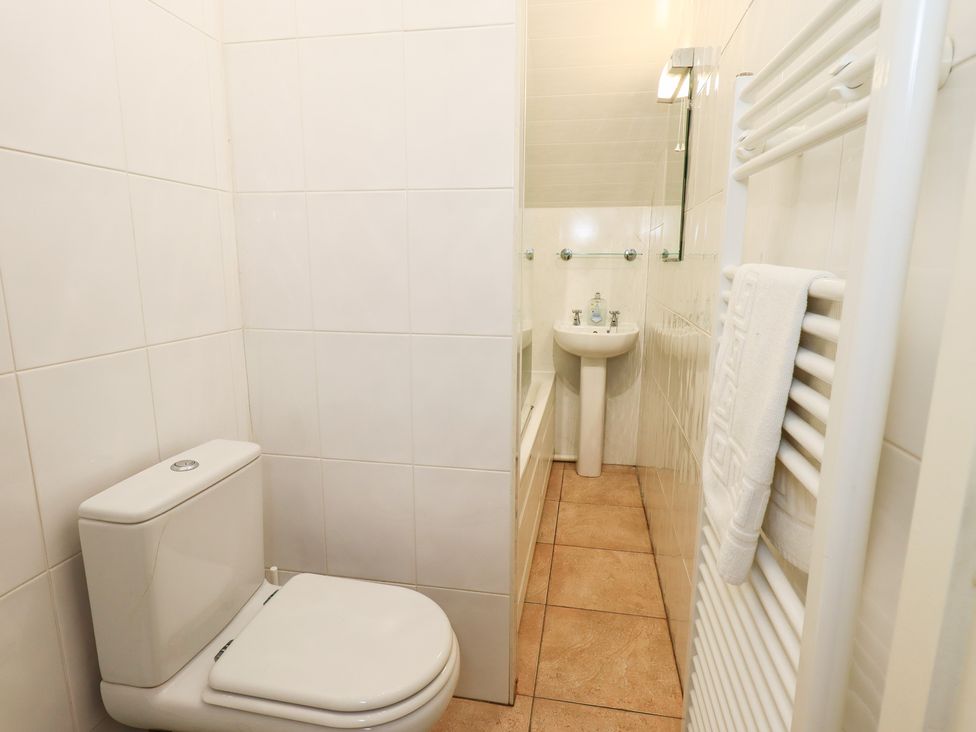 A bathroom with a toilet, sink, and towel rail at Hazelmere in Keswick