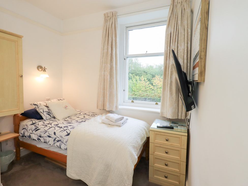 A bedroom with a bed and nightstand at Hazelmere in Keswick