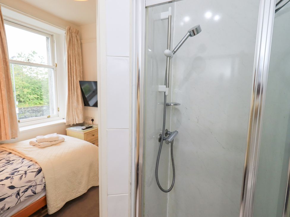 A bedroom with a shower cubicle and a bed at Hazelmere in Keswick