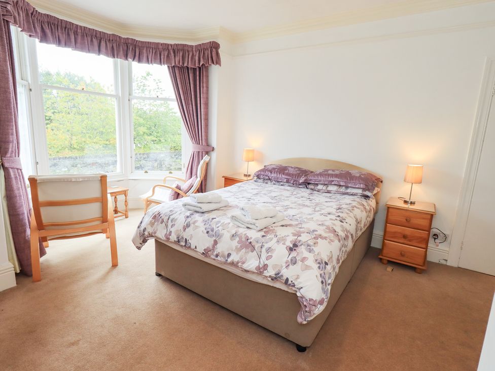 A bedroom with a bed and chair at Hazelmere in Keswick