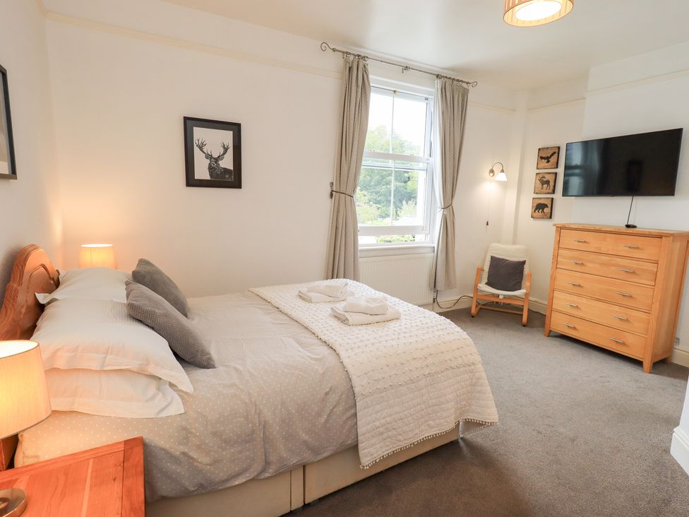 A bedroom with a bed and dresser at Hazelmere in Keswick