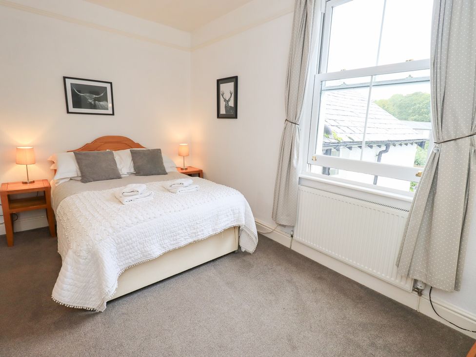 A bedroom with a bed and nightstands at Hazelmere in Keswick