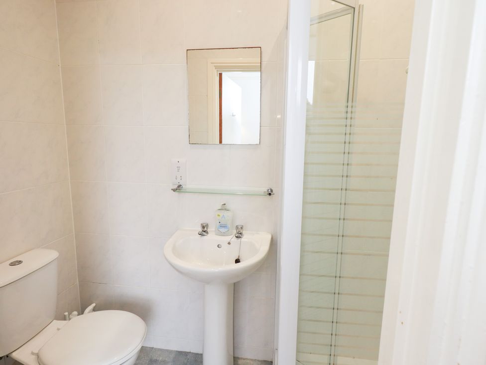 A bathroom with toilet, sink, and shower at Hazelmere in Keswick