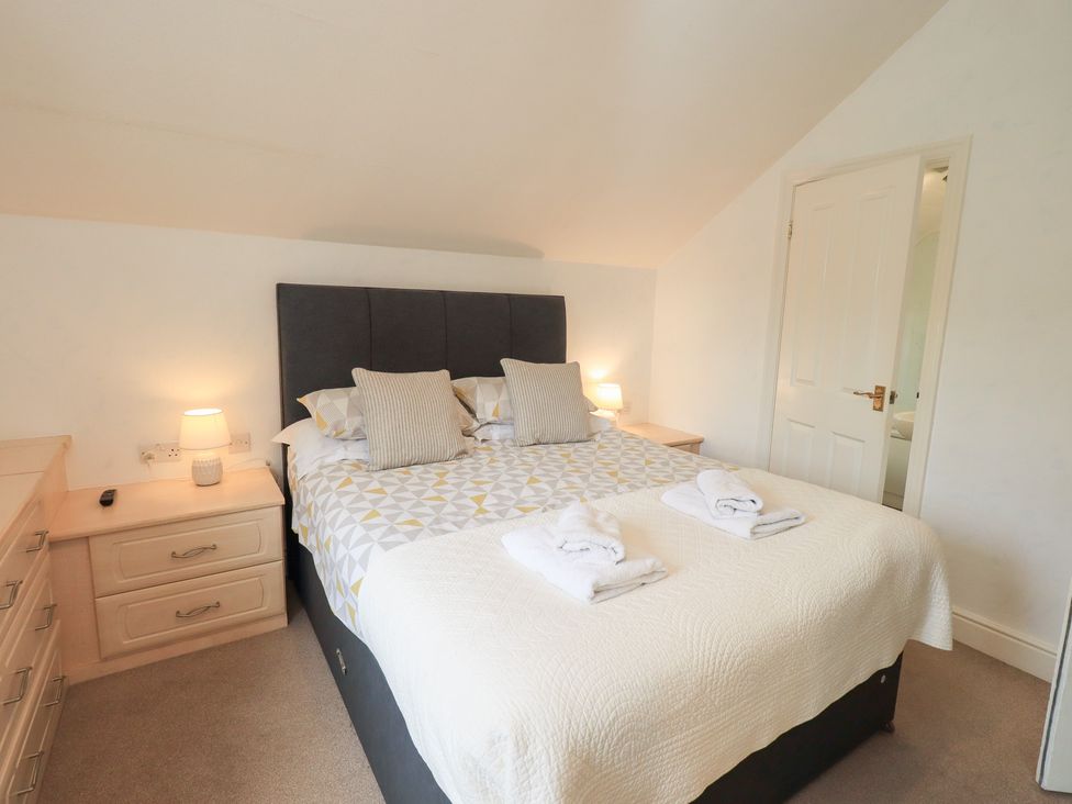 A bedroom with a bed and nightstand at Hazelmere in Keswick