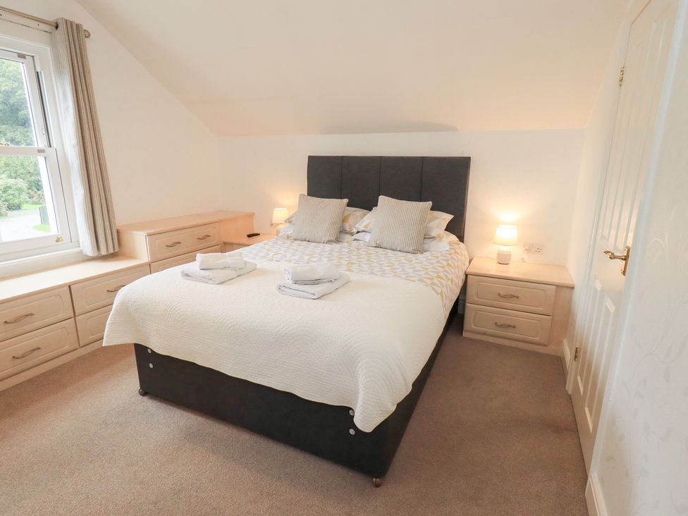 A bedroom with a double bed and bedside lamps at Hazelmere in Keswick
