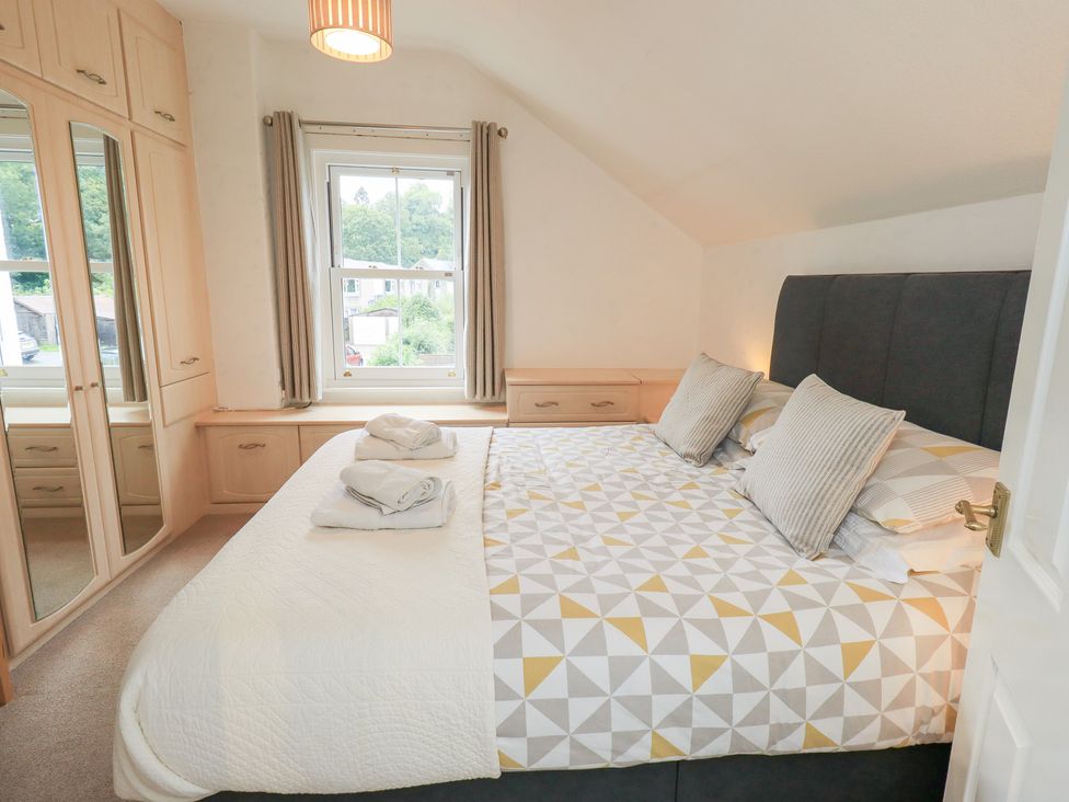 A bedroom with a bed and wardrobe at Hazelmere in Keswick