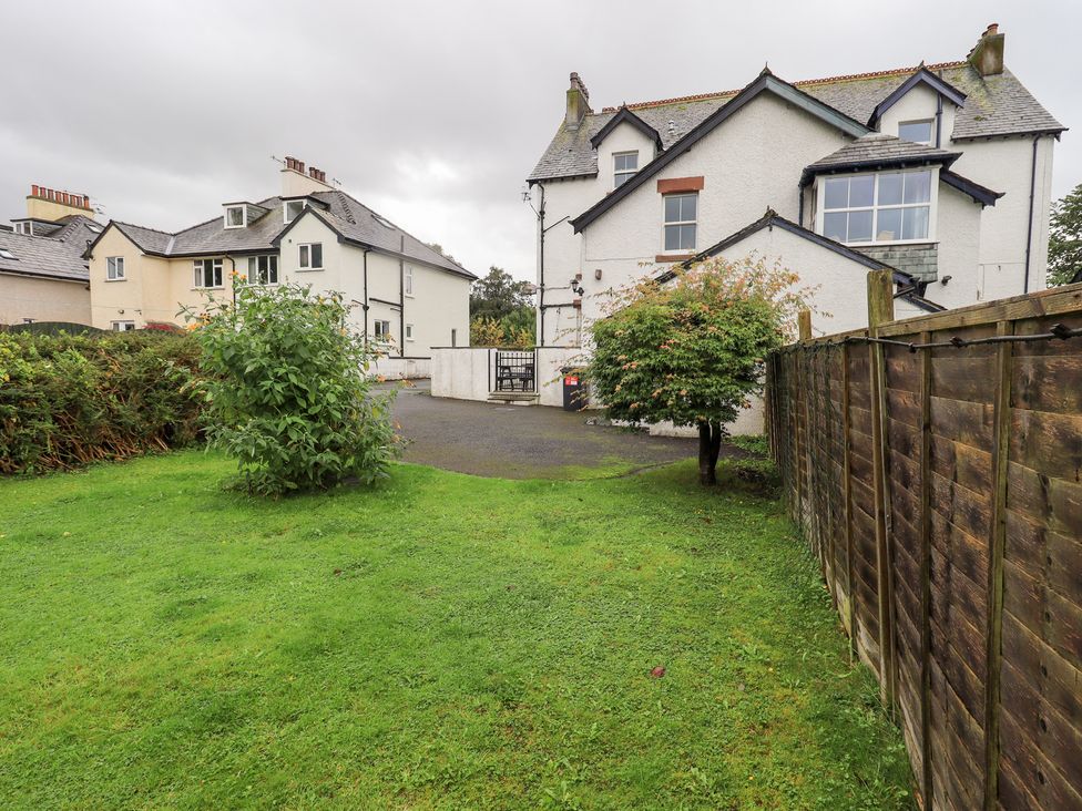 A garden area with a house and fence at Hazelmere in Keswick