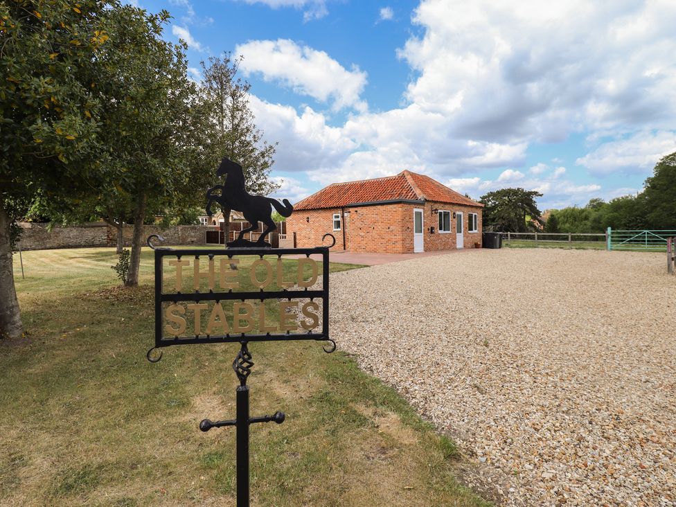 A sign and building at The Old Stables in Folkingham