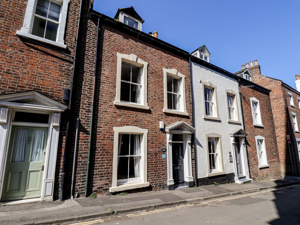 A row of brick houses on a street at Charlotte House in Whitby