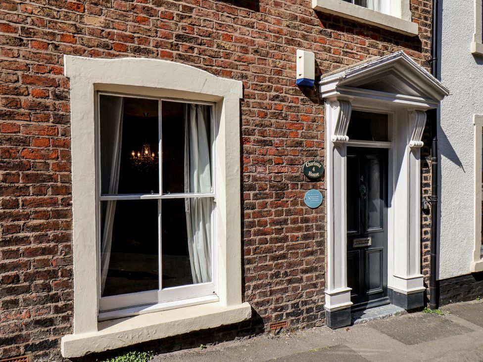 An exterior view of Charlotte House featuring a window and door in Whitby