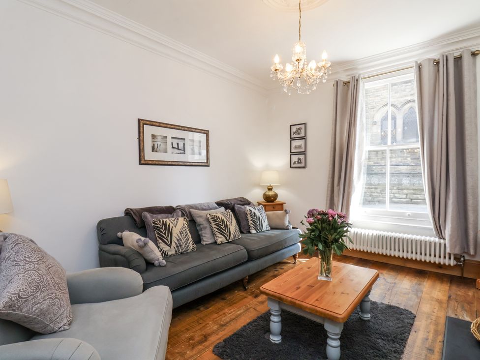 A living room with a sofa and coffee table at Charlotte House in Whitby