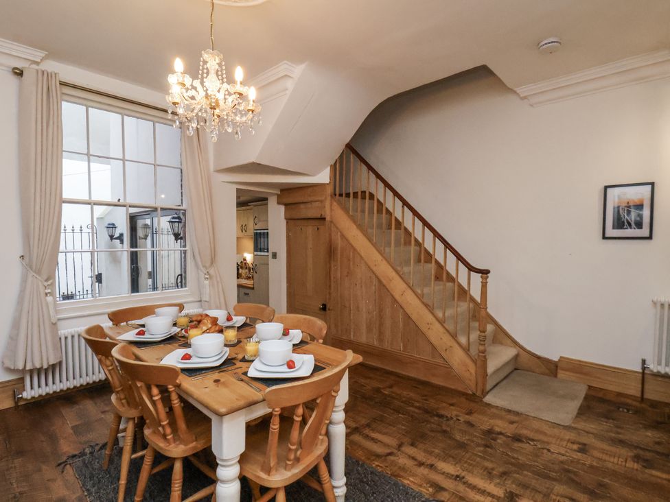 A dining room with a table and chairs at Charlotte House in Whitby