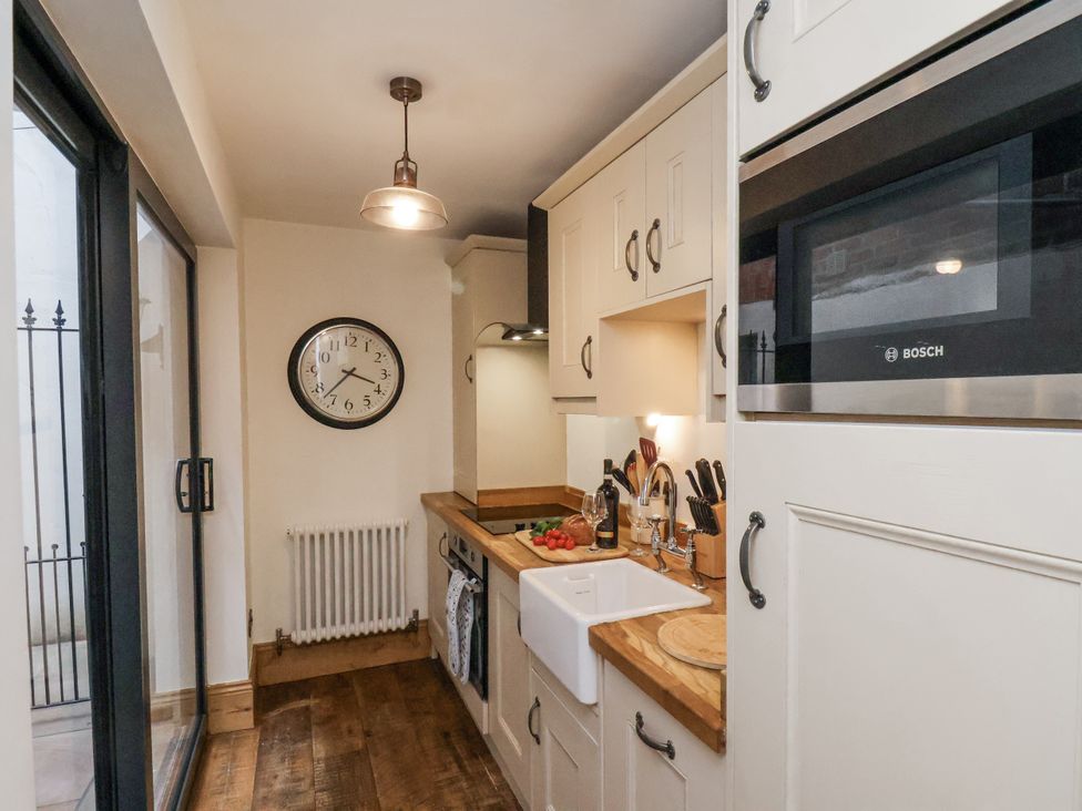 A kitchen with a sink and cabinets at Charlotte House in Whitby