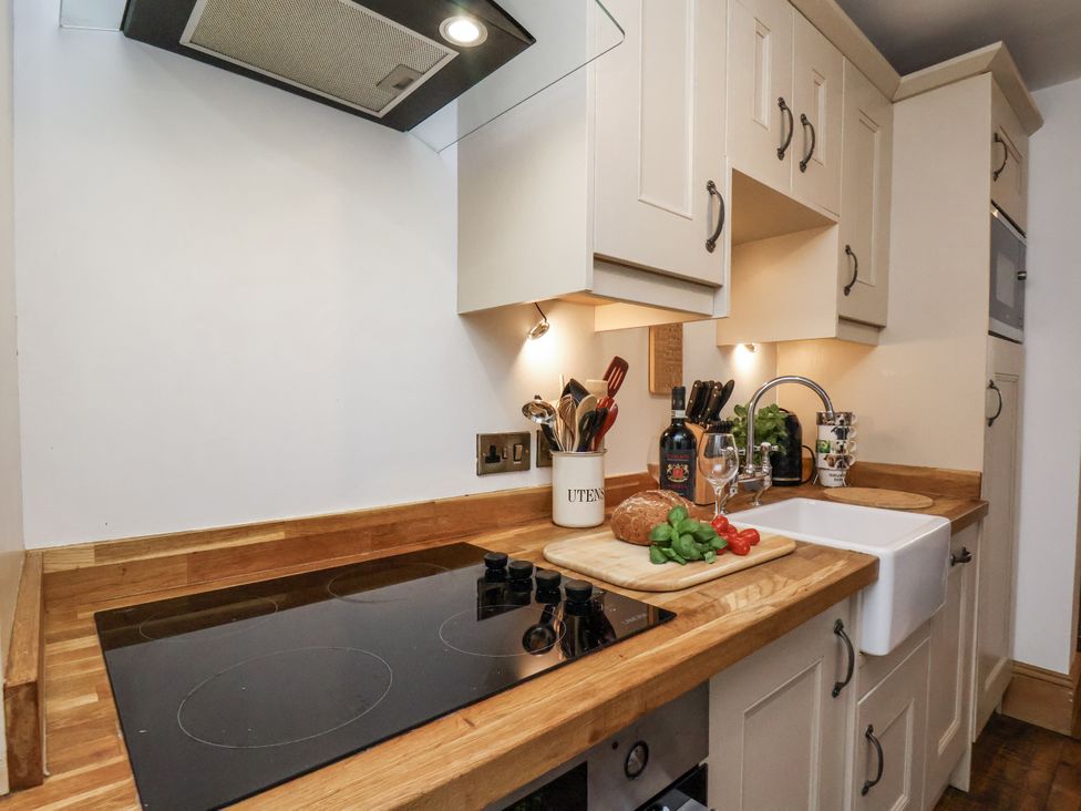 A kitchen with a cooking stove and sink at Charlotte House in Whitby