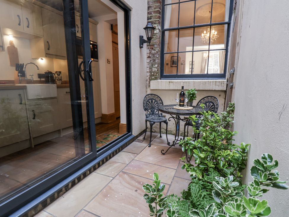 A small patio area with a table and chairs at Charlotte House Whitby